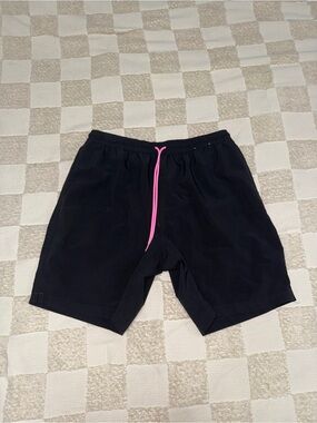 black Chubbies men's swim trunks featuring a neon pink flamingo Large